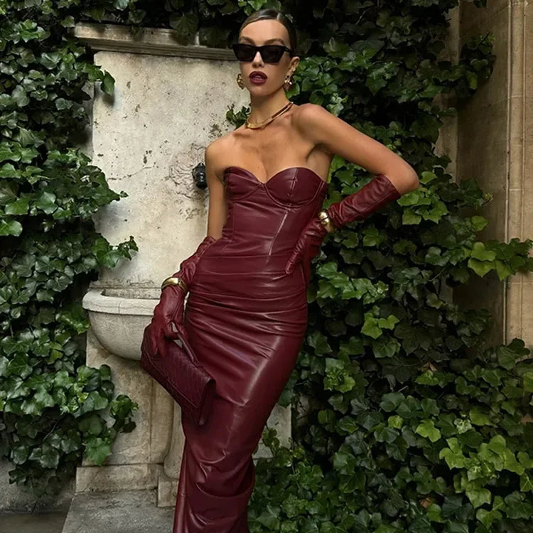 a woman wearing a red a-line, angkle-length dress with feather detailing and spaghetti straps  