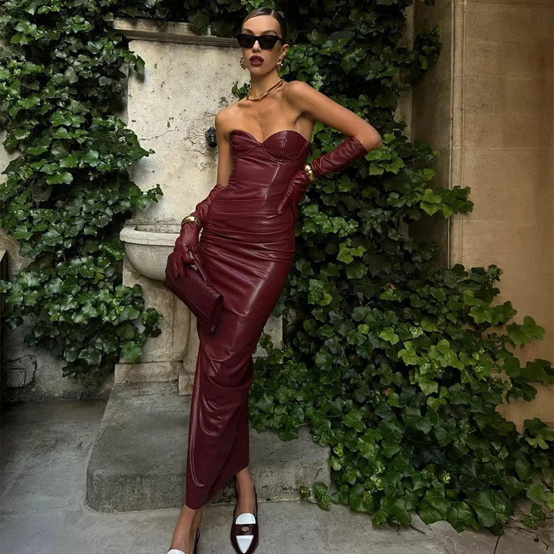 a woman wearing a red a-line, angkle-length dress with feather detailing and spaghetti straps  